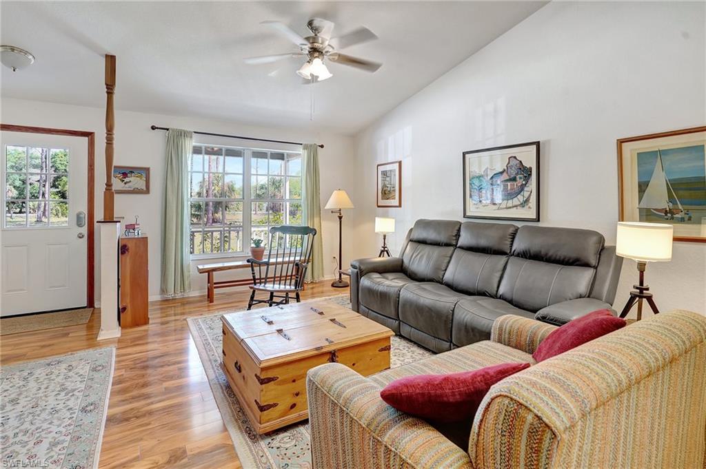 3520 2nd Avenue Northeast Naples, FL 34120 - Photo 19 of 39 a living room with furniture a table and a large window
