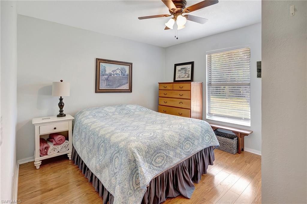 3520 2nd Avenue Northeast Naples, FL 34120 - Photo 21 of 39 a bedroom with a bed and a chandelier