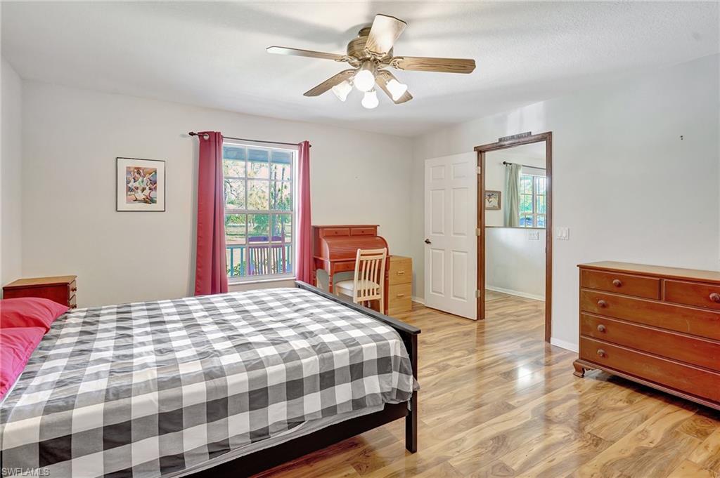 3520 2nd Avenue Northeast Naples, FL 34120 - Photo 27 of 39 a bedroom with a bed and wooden floor