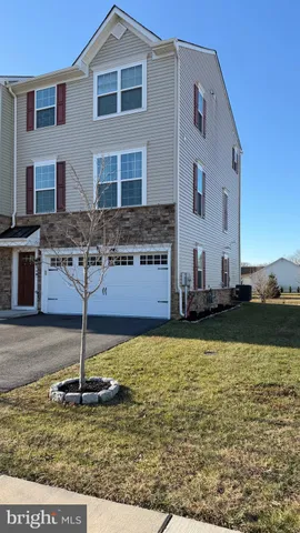 a house view with a swimming pool in front of it