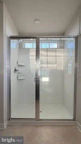 a bathroom with a glass shower door