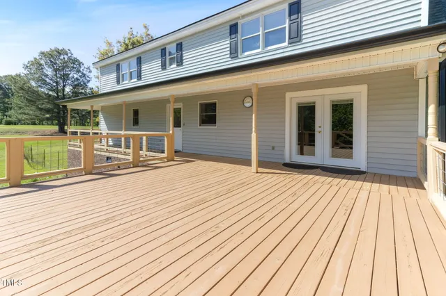 a swimming pool view from balcony with seating space