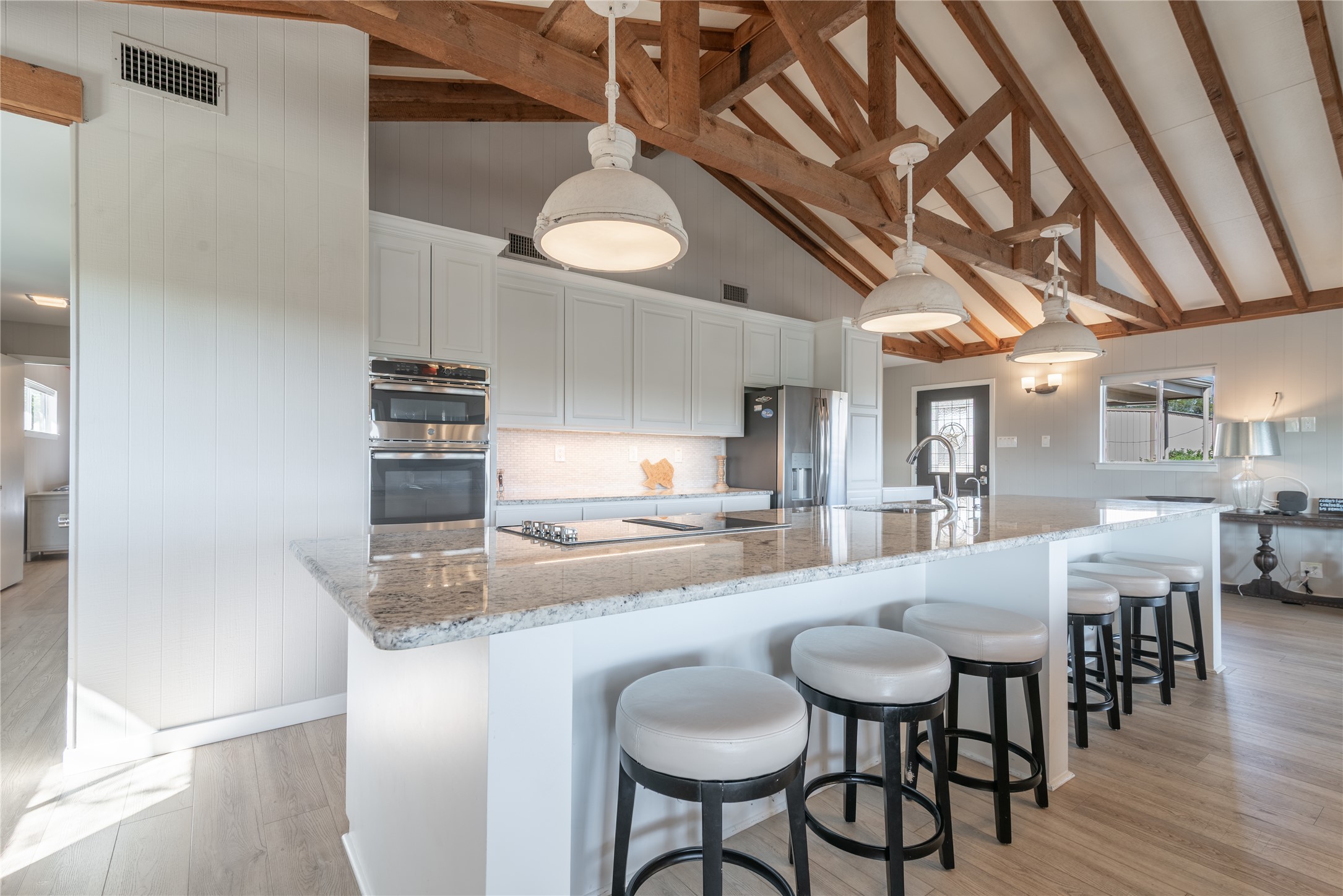 3807 Boat Dock Road Lago Vista, TX 78645 - Photo 3 of 37 Exposed wood beams crown this spacious kitchen, boasting an expansive island with ample seating.