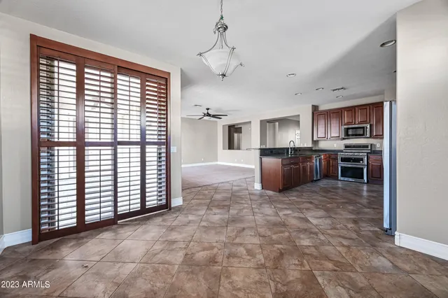 a large kitchen with kitchen island a stove a counter space and cabinets