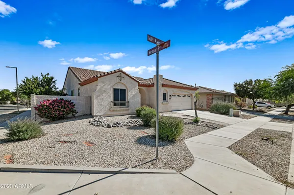 a front view of a house with plants
