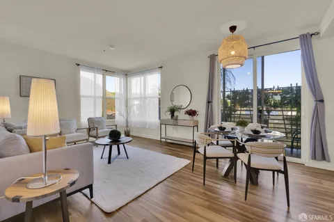 a living room with furniture a table and a large window