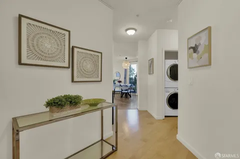 a hallway with painting and white walls