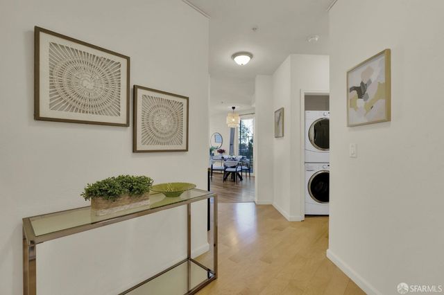 a hallway with painting and white walls