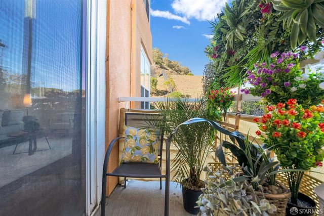 a view of balcony with two potted plants