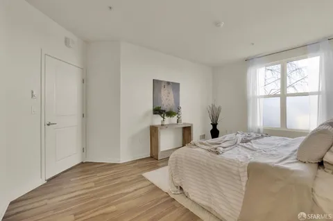 a bedroom with a bed and a large window