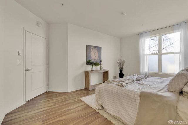 a bedroom with a bed and a large window