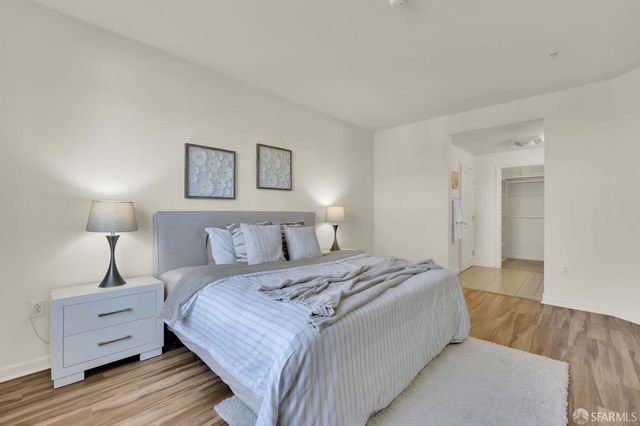 a bedroom with a bed and a night stand