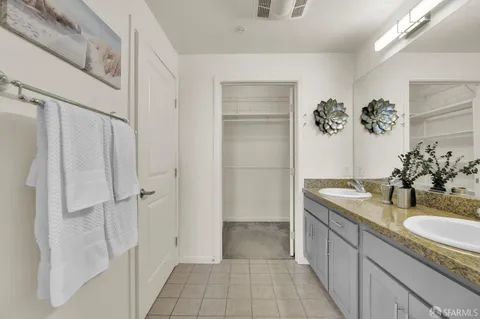 a bathroom with a granite countertop sink a mirror and a shower