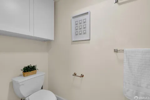 a white toilet sitting next to a shower