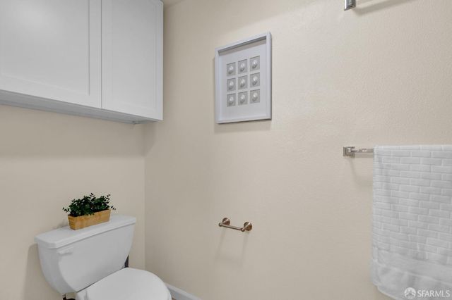a white toilet sitting next to a shower