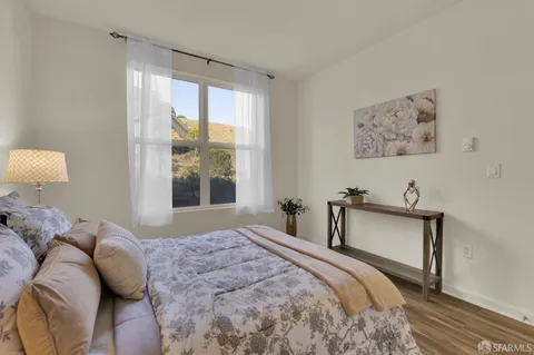 a bedroom with a bed and a large window