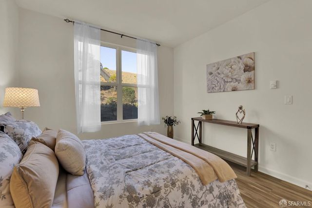 a bedroom with a bed and a large window