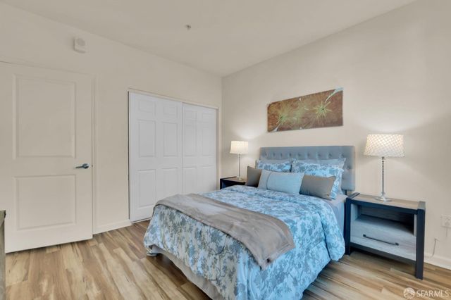 a bedroom with a bed and a night stand