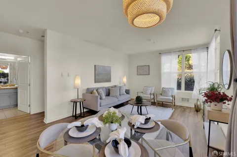 a view of a dining room with furniture wooden floor and chandelier