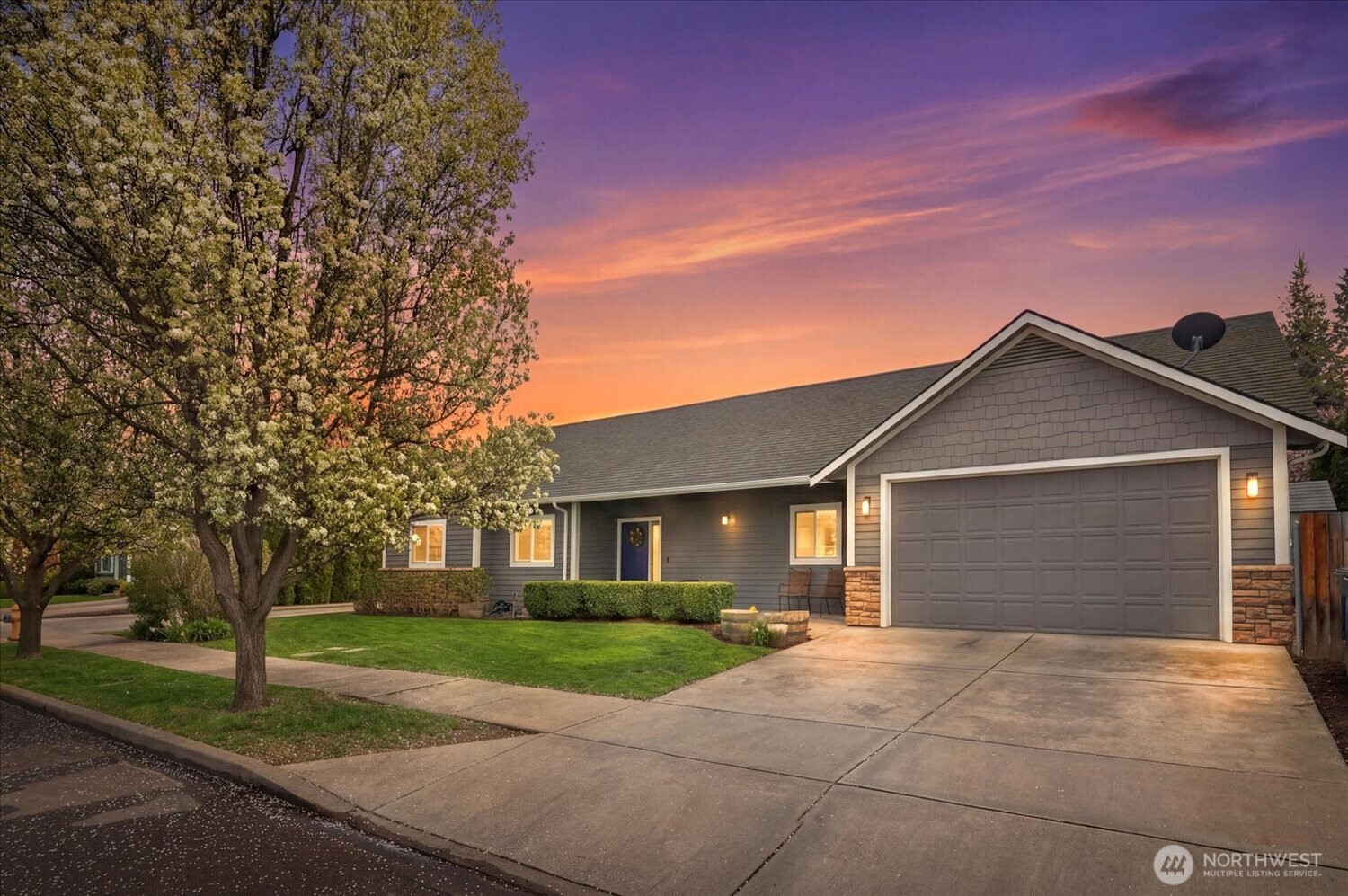 1855 Woodmere Loop Walla Walla, WA 99362 - Photo 1 of 22 a front view of a house with a yard and garage