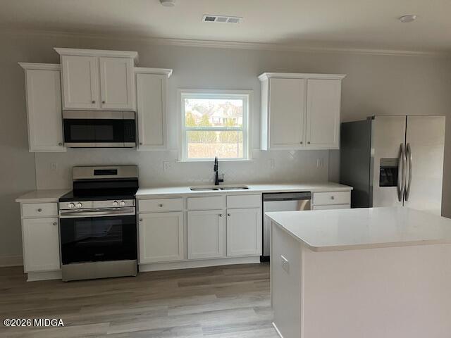 228 Trellis Walk Macon, GA 31220 - Photo 8 of 22 a kitchen with a stove a sink and a microwave