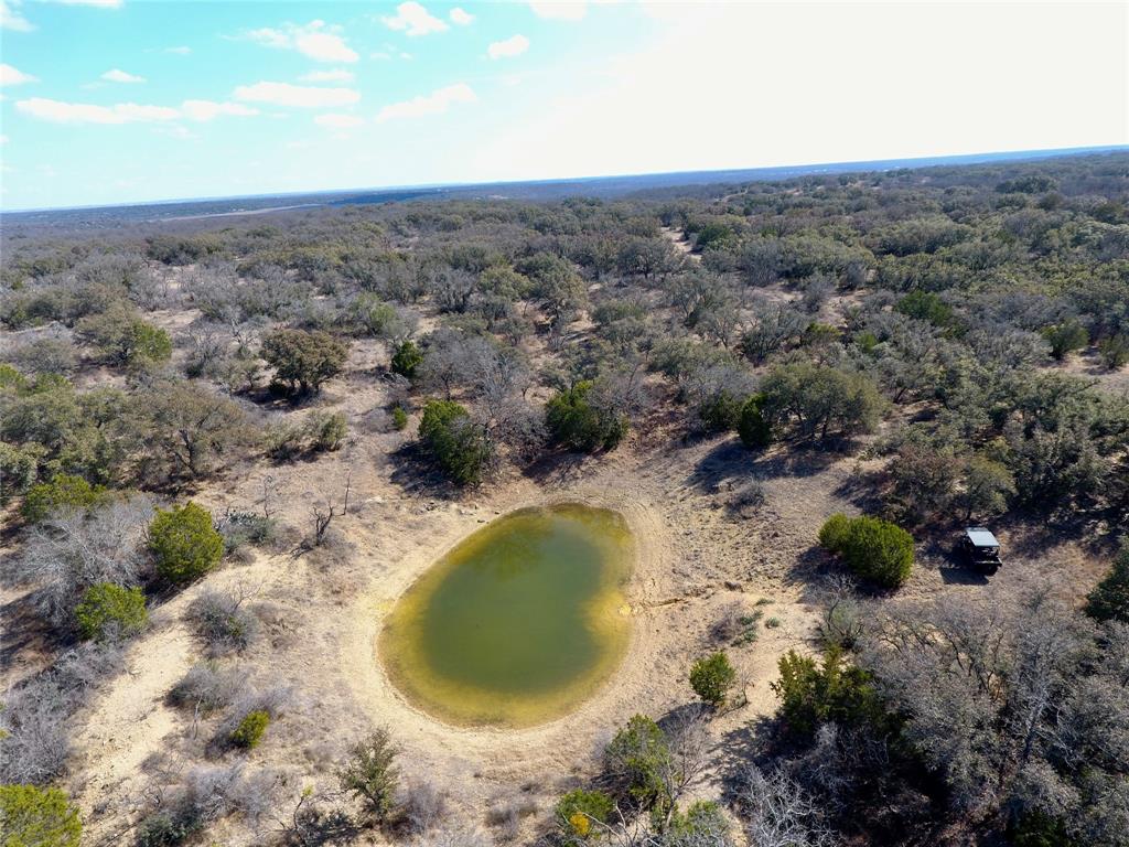 219 C R 550 Mullin, TX 76864 - Photo 2 of 36 an aerial view of a house with a yard and lake view