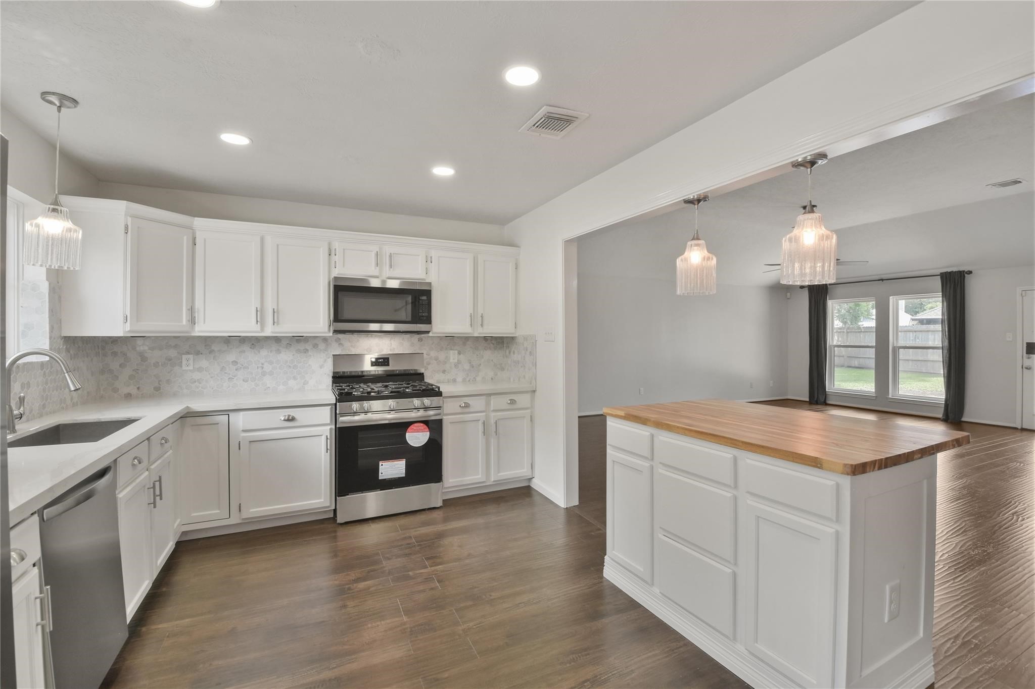 5014 Temple Bell Drive Spring, TX 77388 - Photo 11 of 30 White cabinetry, tiled backsplash, recessed lighting, tons of storage and counterspace.