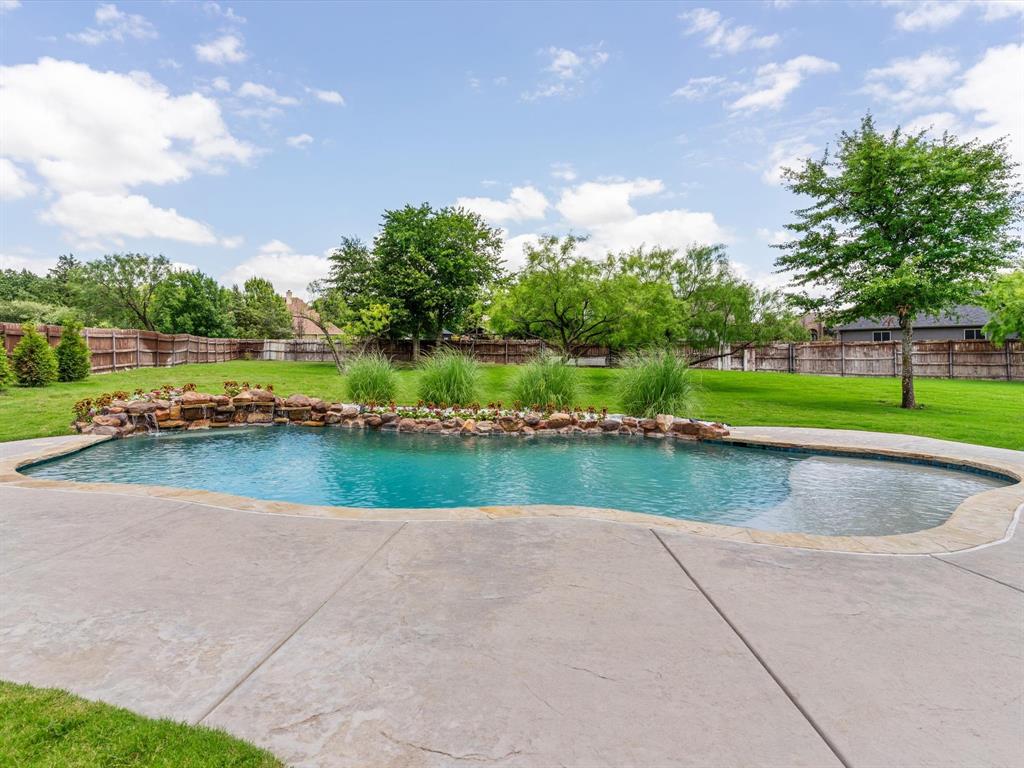 111 Old Base Road Aurora, TX 76078 - Photo 32 of 38 Resort-style saltwater pool and spa surrounded by professional landscaping and outdoor living spaces.