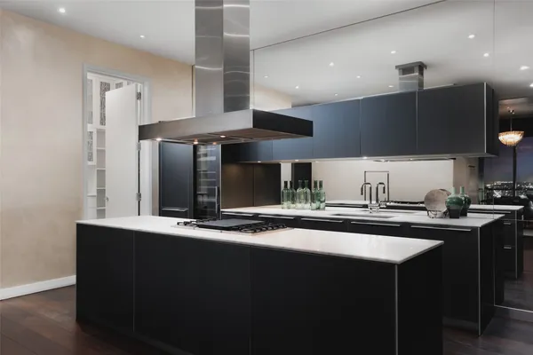 a kitchen with stainless steel appliances granite countertop a sink a stove and a refrigerator