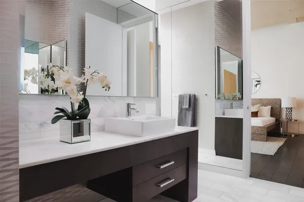 a bathroom with a sink double vanity and a mirror