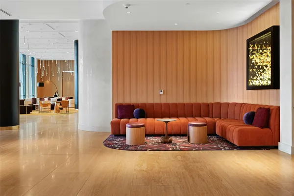 a dining hall with stainless steel appliances granite countertop a dining table and chairs with wooden floor