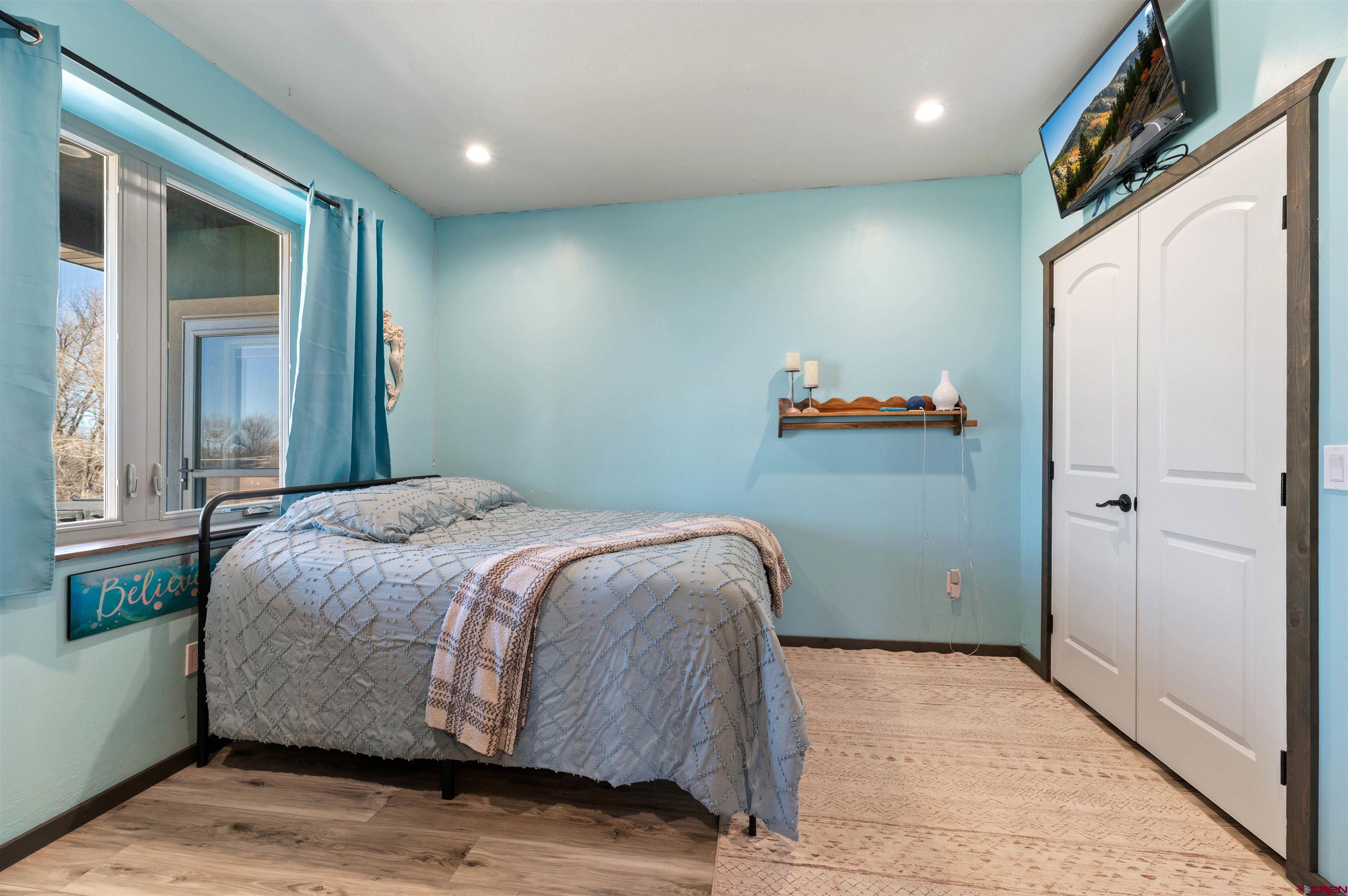 55347 Begonia Road Delta, CO 81416 - Photo 16 of 44 a bedroom with a bed and a window