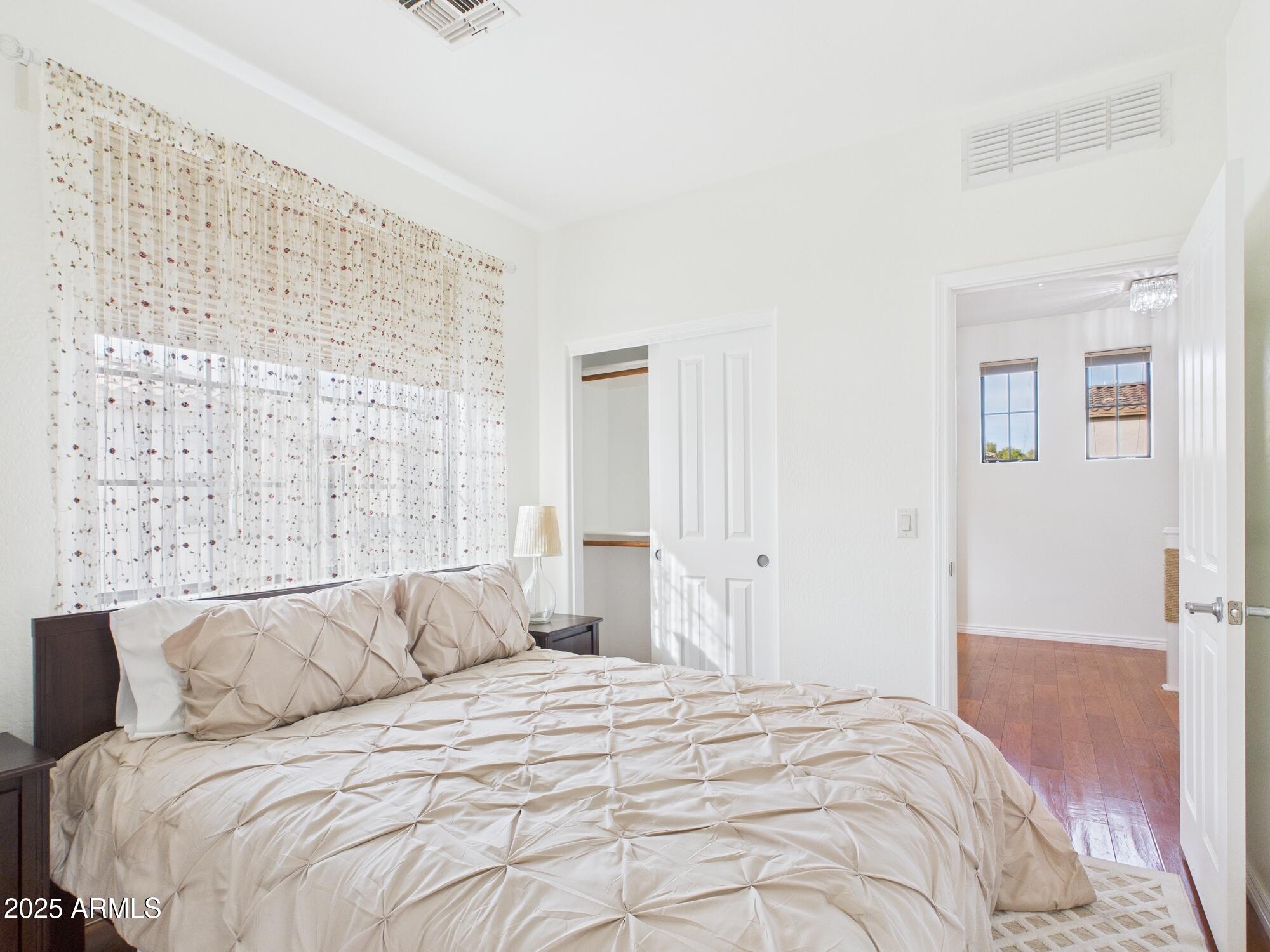 a bedroom with a bed and a window