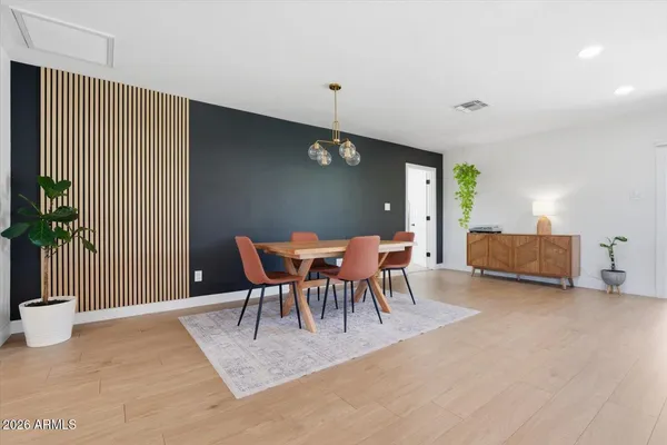 a living room with furniture and a view of kitchen