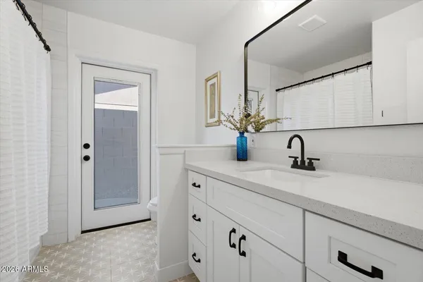 a bedroom with a bed and a chair