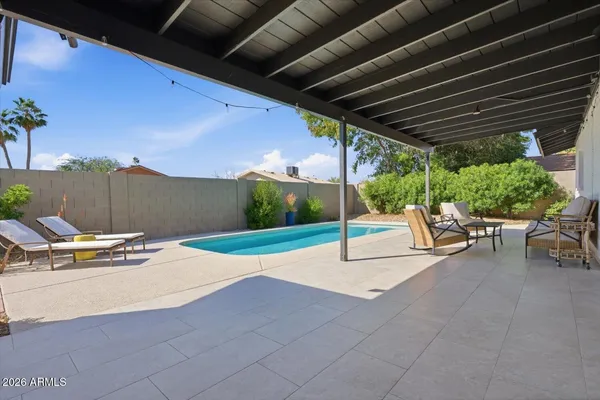 a view of a house with swimming pool and sitting area