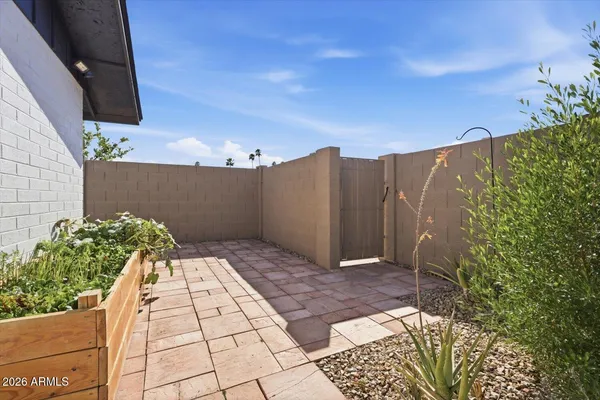 a view of a patio with table and chairs with wooden floor and fence