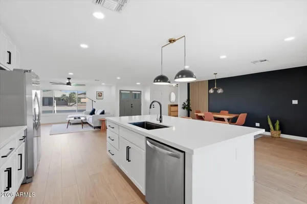 a kitchen with cabinets and steel appliances