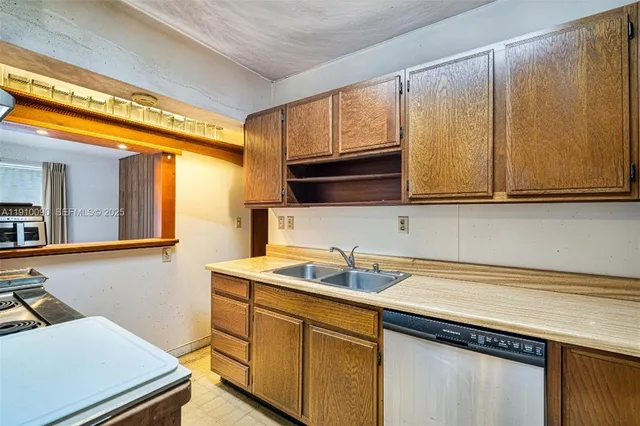 a kitchen with a sink cabinets and a wooden floor