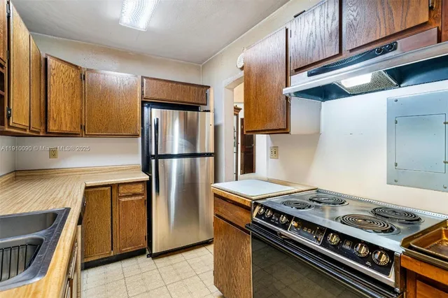 a kitchen with stainless steel appliances granite countertop a stove and a refrigerator