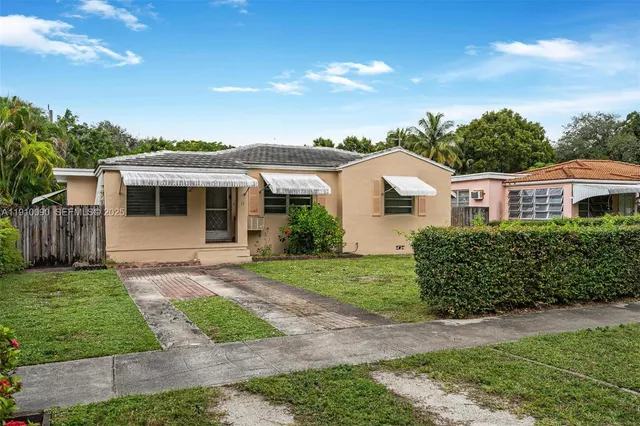 a front view of a house with a garden