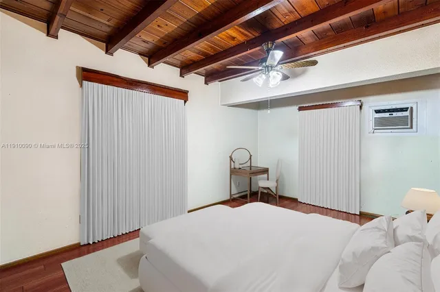 a bedroom with a bed and a wooden floor