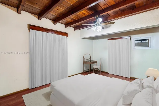 a bedroom with a bed and a wooden floor