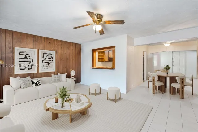 a living room with furniture and a dining table with wooden floor