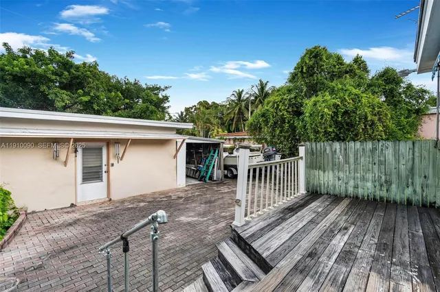 a view of a wooden deck and a backyard