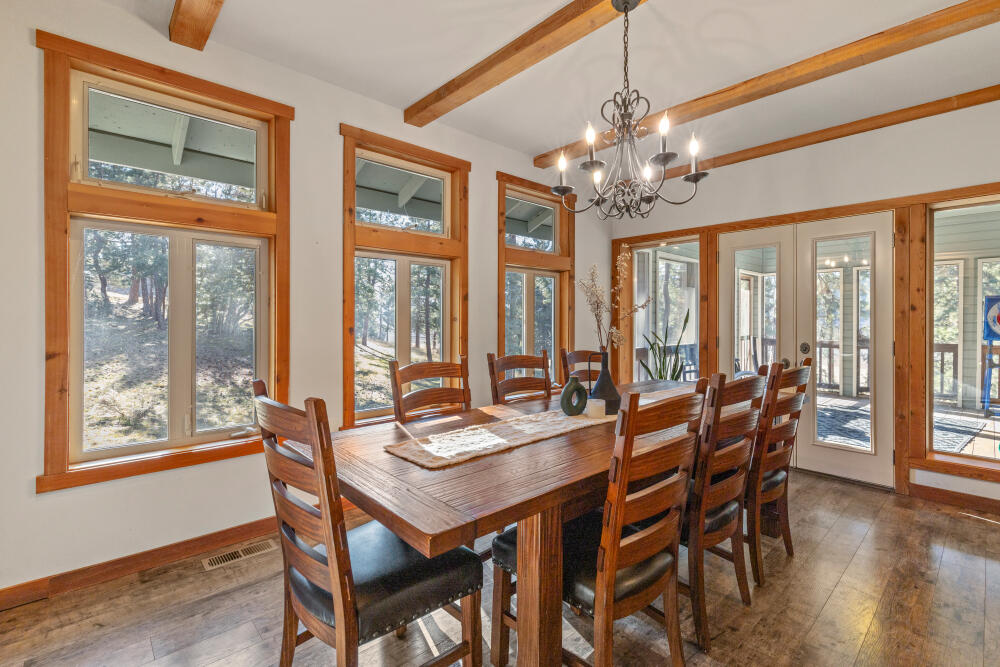 11750 Merganser Road Klamath Falls, OR 97601 - Photo 22 of 66 a view of a dining room with furniture wooden floor and chandelier
