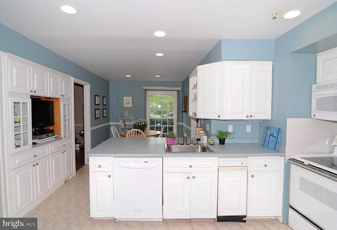 7613 Sebago Road Bethesda, MD 20817 - Photo 2 of 26 a kitchen with counter top space cabinets and stainless steel appliances