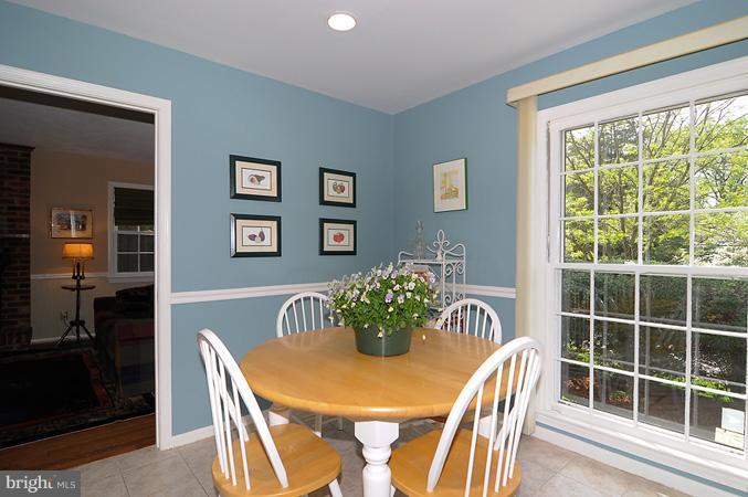 7613 Sebago Road Bethesda, MD 20817 - Photo 13 of 26 a view of a dining room with furniture and wooden floor