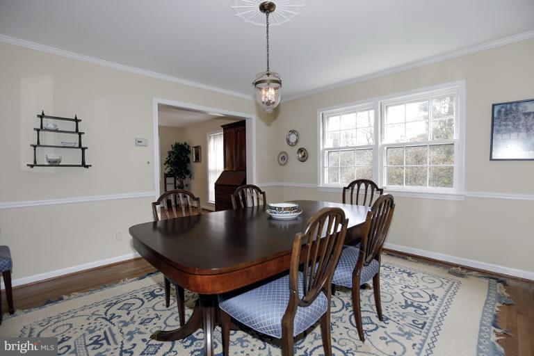 7613 Sebago Road Bethesda, MD 20817 - Photo 17 of 26 a view of a dining room with furniture window and wooden floor