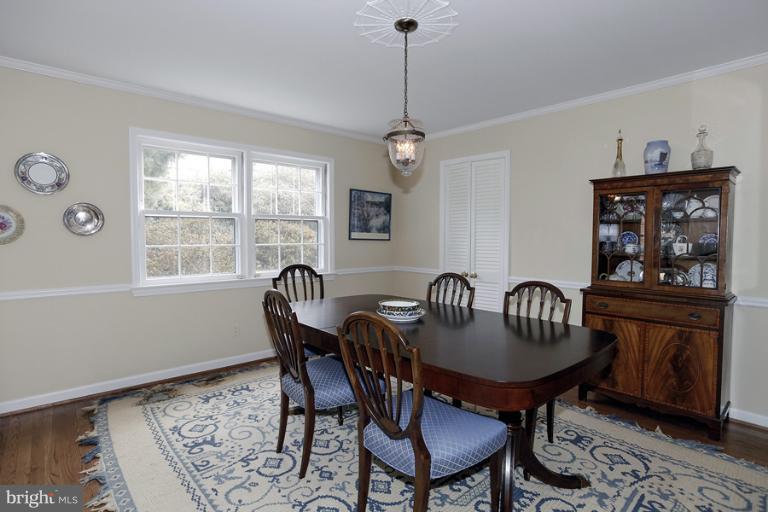 7613 Sebago Road Bethesda, MD 20817 - Photo 19 of 26 a view of a dining room with furniture window and wooden floor